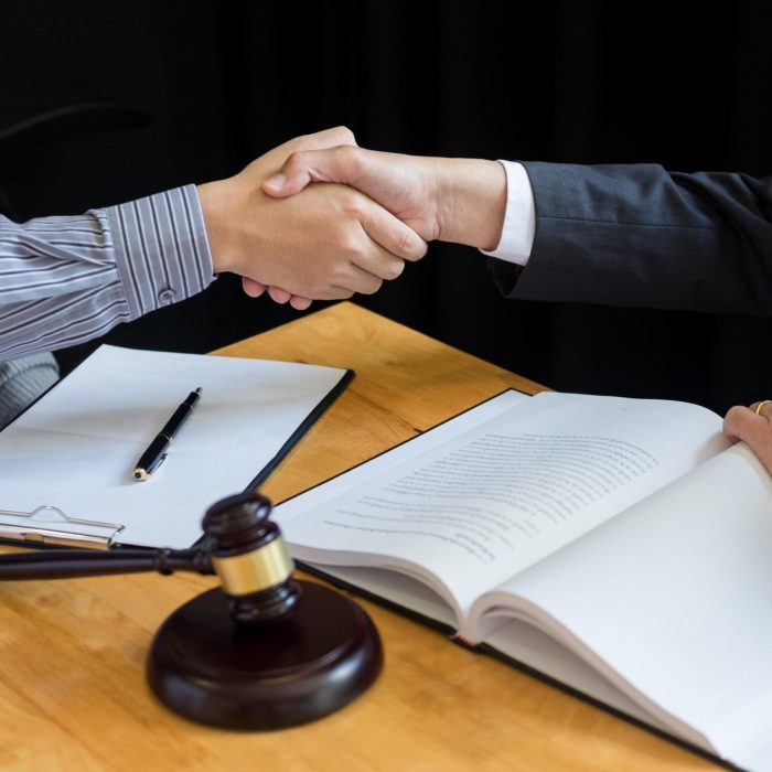Law and Legal concept, Consultation between attorneys and clients customer shaking hands discussing contract agreement In Courtroom